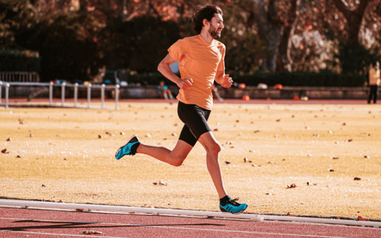 A beginner runner practices proper form on a track, focusing on foot placement and stride length