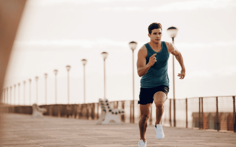 A runner follows a training plan, with a schedule and distances marked on a calendar, while wearing running shoes and headphones